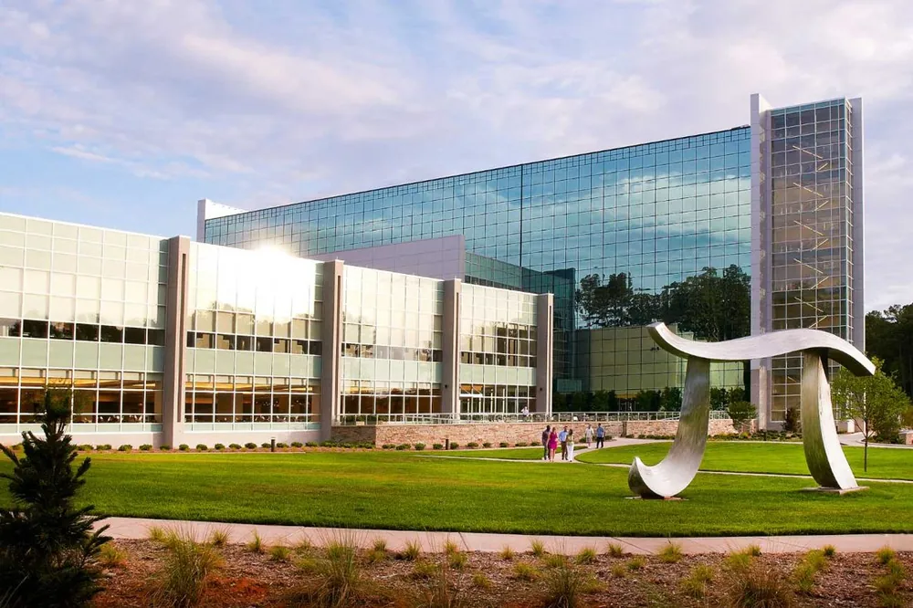 Glass office campus with sculpture on the lawn